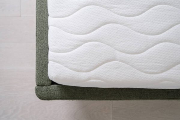 top view of new foam orthopedic mattress with white cotton surface on modern bed at home, comfort sleeping concept